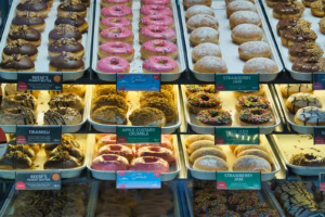 Assorted donuts displayed in a bakery case.